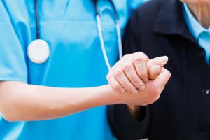 Nurse holding patients hand.
