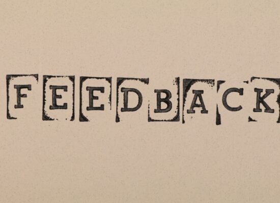 Stamped letters that spell the word 'feedback'