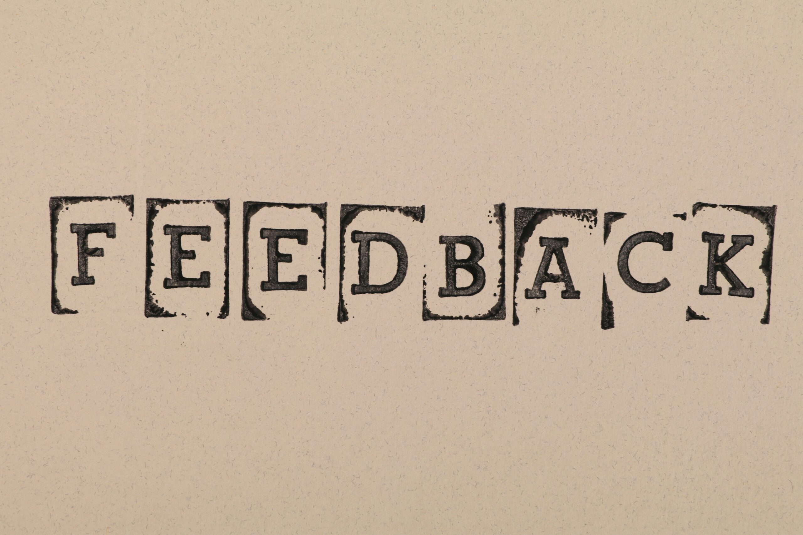 Stamped letters that spell the word 'feedback'